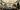 BAC_Commercial_Photography_Full_Res-216 A party of people in the octagonal hall, a room with arches supported by marble pillars, a classical style statue in the left hand corner, and a stained glass domed ceiling. There is a table of filled champagne flutes on the right