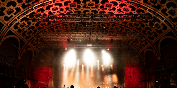 Grand Hall - UK Beatbox Championships 2018 PHOTOCREDIT - The Conference Factory BeatBoxChampA-4 resize2 A photo taken from behind a crowd gathered at a concert in our Grand Hall. Spotlights shine down from the wooden lattice roof and illuminate the stage.