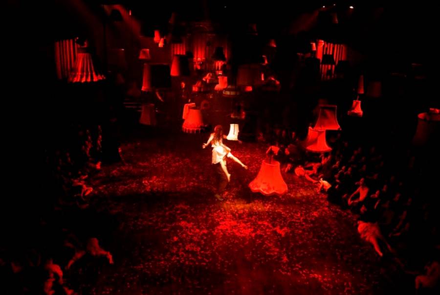 POINT 10- The Masque of the Red Death A girl appears to float in the middle of a red lit room, with a number of lampshades also suspended