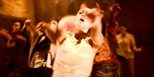 Hofesh Shechters Political Mother The Final Cut An image of a dancer with arms outstretched blurred in front of her.